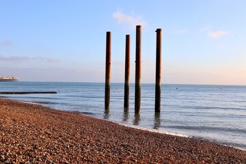 Chimney poles standing on the beach at sunset in Brighton, England