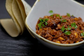 Closeup shot of chilli con carne dish on the table
