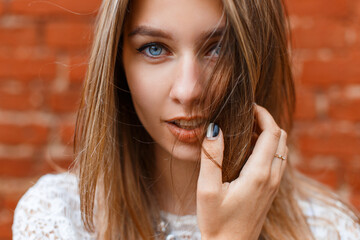 Beautiful street female portrait of a beautiful woman with blue eyes looking at the camera