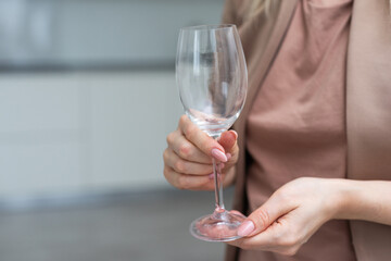 hand holding Empty wine glass isolated on white background