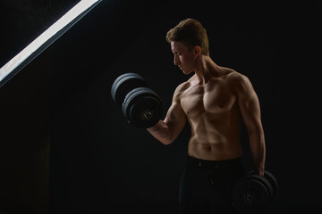  Muscular man with dumbbells on black background. Muscular man with dumbbells on black background. ...