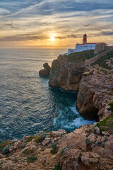 moody view on Cabo Sao Vicente with its famous lighthouse at sunset at the south.estern spit of Europe near Sagres, Algarve, Portugal - 782926536