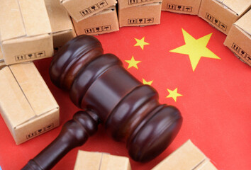 Tariffs and taxes for Chinese production. Flag of China with judge gavel and carton boxes.	