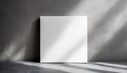 Mock-up of white square canvas on light gray background. Blank poster.