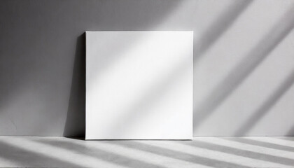 Mock-up of white square canvas on light gray background. Blank poster.
