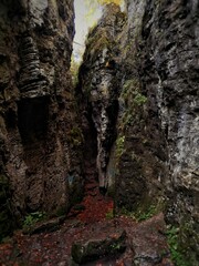 Beautiful vertical view of huge rocks with wet stones on a ground