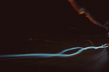 Long exposure shot of trails of lights on a dark background