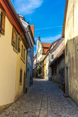 Fototapeta na wymiar Vertical shot of the narrow street between the buildings in Rothenberg ob der Tauber, Germany
