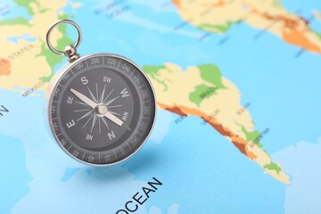 One compass on world map, space for text. Tourist equipment