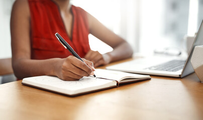 Hand, writing and notes in notebook from home office with schedule for business or ideas in...