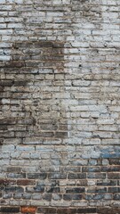 Vertical shot of a faded brick wall for backgrounds and overlays