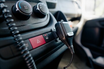 Closeup shot of the Bluetooth adapter, emergency button and AC button in a modern car