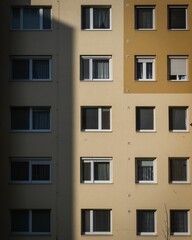 Fototapeta na wymiar Vertical shot of the exterior of a beige residential building