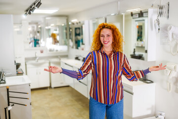 Portrait of salesperson in bathroom store. Happy redhead woman works in bath store. Sales occupation. - 782942115