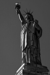 Vertical grayscale shot of the historic Statue of Liberty in New York