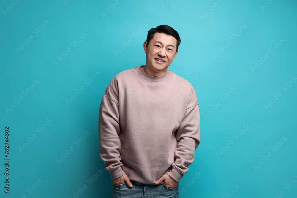 Poster Portrait of happy man on light blue background