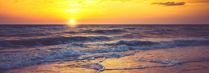 Seascape in the early morning. Sunrise over the sea. Surf line. Horizontal banner