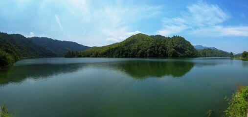 Panoramic view of beautiful forested mountains and lake