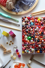 Various craft supplies on white background. Supplies for jewelry making, drawing and needlework. Flat lay.