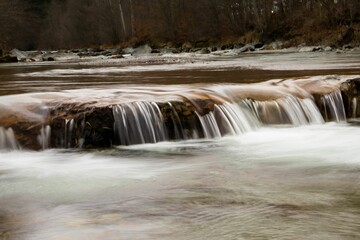Fototapeta premium Beautiful view of a scenic waterfall water flowing