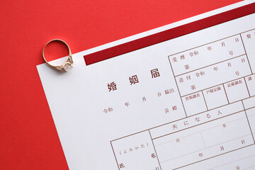 Japanese marriage registration blank document and wedding proposition ring on table close up