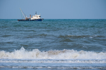 Fishing boat sailing in rough seas