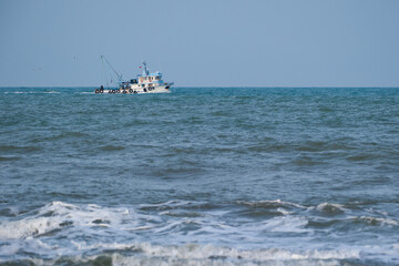 Fishing boat sailing in rough seas