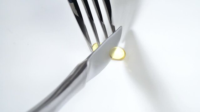 Eat pills with fork and knife on a white background - Turn around animation