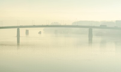 View of the Varadin Bridge and the Danube River covered with autumn fog - Powered by Adobe