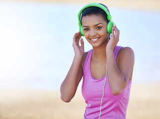 Fitness, portrait and woman with headphones outdoor listening to music, podcast or radio for...
