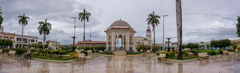 Panoramic shot of the Glorieta de Manzanillo park under a cloudy sky in Manzanillo, Cuba.