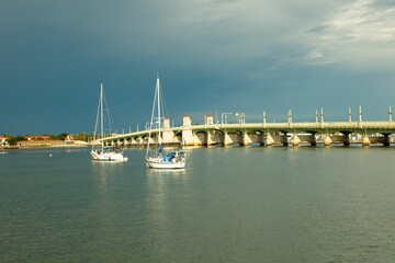 Fototapeta premium Historical St Augustine Bridge with sailboats on the sea