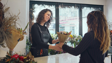 Florist woman make bouquet diy. Hand made floral home decor. Happy girl work flower shop. Modern...
