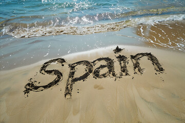 Spain written in the sand on a beach. Spanish tourism and vacation background - 782972991