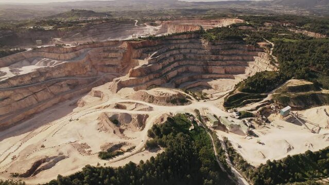 This image features an aerial view of a vast limestone quarry with detailed layers and mining equipment.