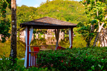 picturesque bright nature and pavilion in Seychelles, lake and granite stones