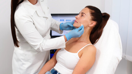 Close-up. Before the procedure for facial contouring or plastic surgery, the cosmetologist makes markings on the patient’s face. Time to prepare for a cosmetic procedure.