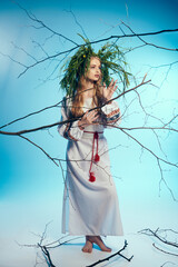 A young mavka in a white dress delicately balances a plant on her head in a studio setting, embodying fairy-like grace.
