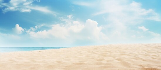 Fototapeta premium Sandy beach with blue sky and clouds
