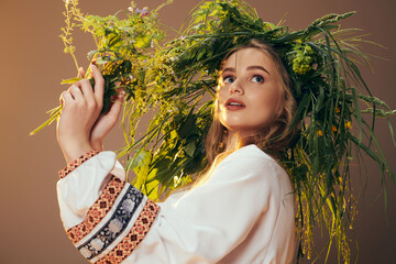 Young woman wearing a traditional outfit adorned with a fairy and fantasy-inspired flower crown in a studio setting.