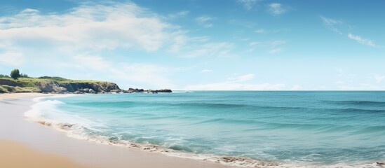 Obraz premium Blue sea meets sandy beach