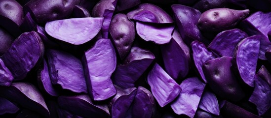 Purple potatoes piled on table