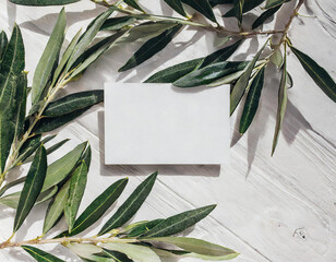 Summer stationery, blank business card mock-up scene. Horizontal greeting card with blooming green olive tree leaves, branch isolated on white table background. Mediterranean flat lay, top view.