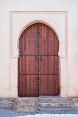 Traditional Moroccan ancient wooden entry door. In the old Medina in Marrakech, Morocco. Typical,...
