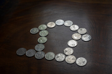 The coins are arranged to form a house