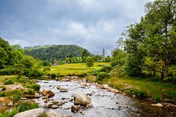 Idyllic view in Glendalough Valley, County Wicklow, Ireland. Mountains, lake and tourists walking...