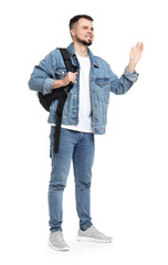 Man with backpack in denim clothes waving hand on white background