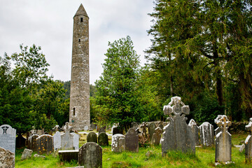 Stone round tower and some ruins of a monastic settlement originally built in the 6th century in...