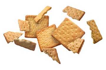 Tasty dry crackers falling on white background