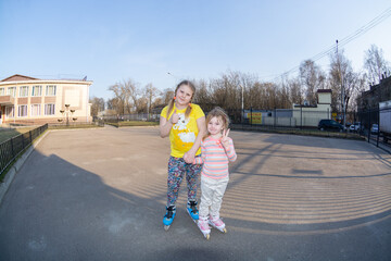 On a warm spring evening, the girls rollerblade.